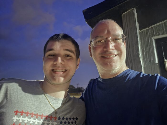 William and his dad Matthew smiling together outdoors