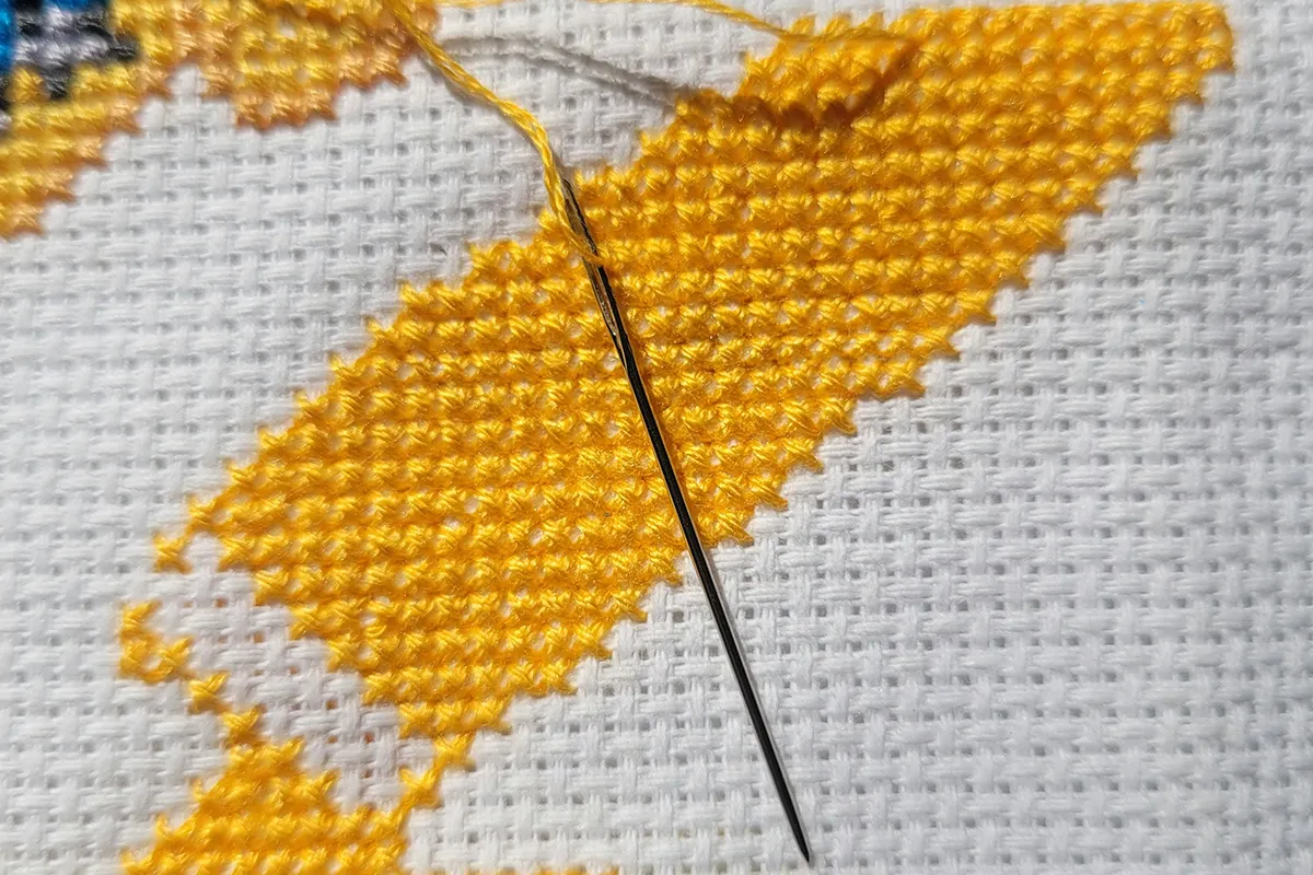 A needlepoint embroidery hoop and thread